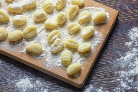 Balkan cuisine. Njoke , potato dumpling on wooden cutting board. Rustic tableの写真素材