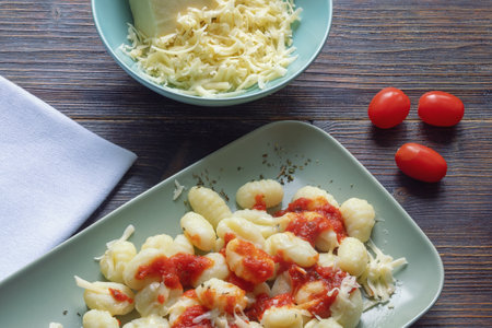 Balkan cuisine. Njoke from potato ( potato gnocchi, dumpling ) with cheese and tomatoの写真素材