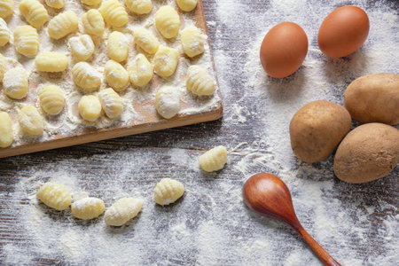 Balkan cuisine. Njoke ( gnocchi , potato dumpling ) on wooden cutting boardの写真素材