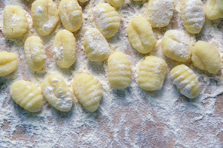 Balkan cuisine. Njoke (dumplings, gnocchi) on table sprinkled with flour. Copy spaceの写真素材