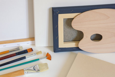 Canvases,  paintbrushes, palette and drawing paper. Copy spaceの写真素材