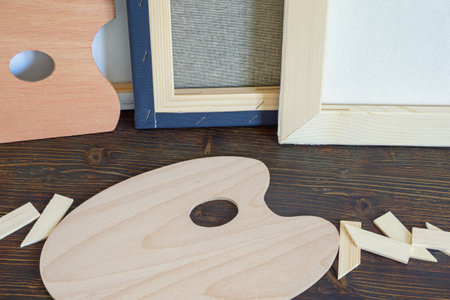 Stretched canvases and wooden palettes on  rustic tableの写真素材