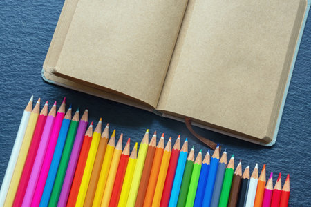 Sketchbook and  bright colour pencils. Copy spaceの写真素材