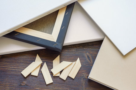 Different canvases and drawing paper on a rustic table