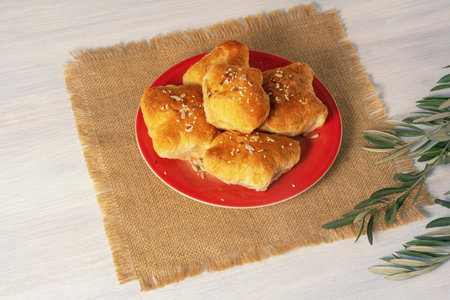 Balkan cuisine. Mantije -  pastry stuffed with meat or cheese. Rustic background, olive tree branch. Copy spaceの写真素材