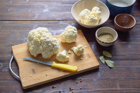 Cauliflower on cutting board on dark rustic table. Copy spaceの写真素材