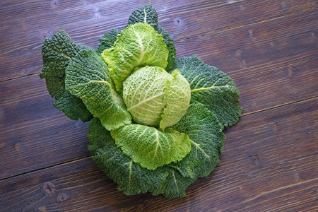 Green vegetables. Savoy cabbage head on dark rustic table. Copy spaceの写真素材