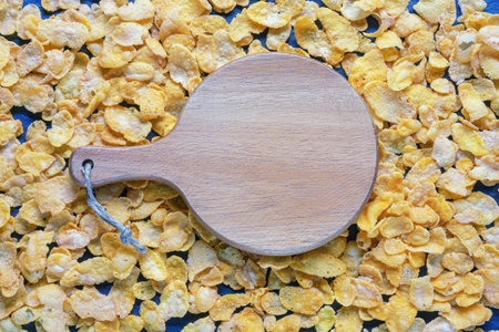 Corn flakes and cutting board on table, background. Copy spaceの写真素材