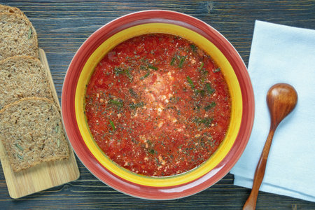 Ukrainian cuisine. Plate with borscht, traditional red beetroot soup, on dark rustic tableの写真素材