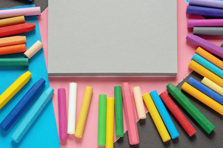 Sketchbook, colored paper and colorful pastel crayons. Copy spaceの写真素材