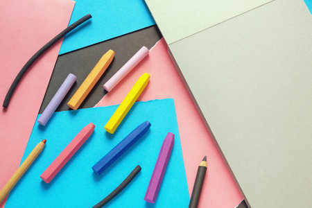 Sketchbook, colored paper and colorful pastel crayons, pencils, charcoal. Free space for text or imageの写真素材