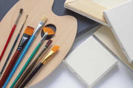 Art tools: canvases,  paper, wooden palette and different paintbrushesの写真素材