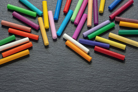 Colorful pastel crayons on dark background. Copy spaceの写真素材