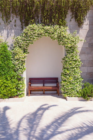 Cozy place to relax on sunny day. Park bench on embankment of Tivat city, Montenegroの写真素材