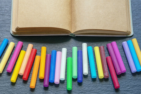 Sketchbook and colorful pastel crayons. Copy spaceの写真素材