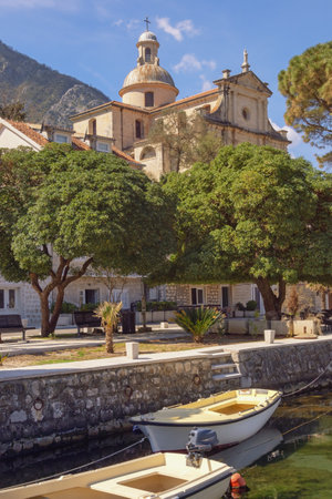 View of ancient Mediterranean town of Prcanj on sunny  day. Montenegro, Adriatic Sea, Bay of Kotor. Birth of Our Lady Churchの写真素材