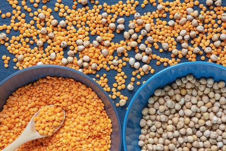 Legumes. Red lentils and chickpeas on dark table. Flat layの写真素材
