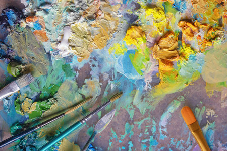 Palette with oil paints, paintbrushes and palette knifeの写真素材