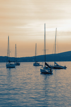 Sailboats on water at sunset.  Beautiful Mediterranean landscape.  Montenegro, coast of Kotor Bay, Tivat. Toned imageの写真素材