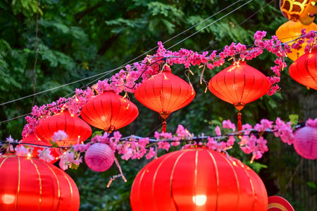 Close-up of the traditional Chinese red lantern with outdoor starry solar string lights. Big red lantern. Festive decoration. Mid-autumn festival, Chinese New Year decoration for cの写真素材