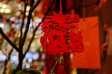 Close-up of the Chinese decoration hanging on the peach blossom plant. New year celebration. Festive decoration and celebration. For background use.の写真素材