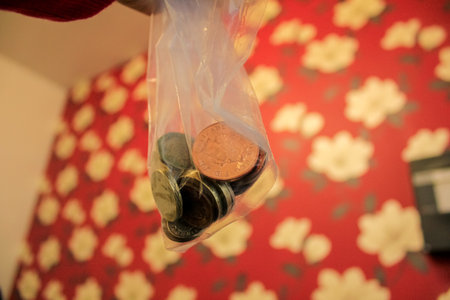A bag of coins with colorful background. Money, currency, cash concepts.の写真素材