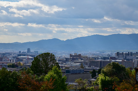 The view of Kyoto city skyline with blue sky and trees from kiyomizu-dera temple in Kyoto, Japan. Major tourist attraction in Kansai region in Japan. Travel concept.の写真素材