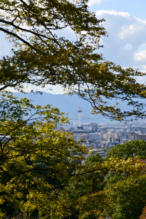 The view of Kyoto city skyline with blue sky and trees from kiyomizu-dera temple in Kyoto, Japan. Major tourist attraction in Kansai region in Japan.の写真素材