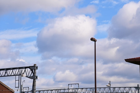 The streetlight with blue cloudy sky. Nature and cityscape.