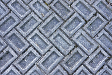 pattern of gray tiles on the street, closeup of photo.