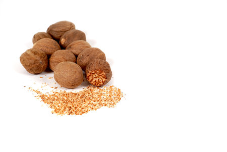 Whole and grated nutmeg isolated on whiteの写真素材