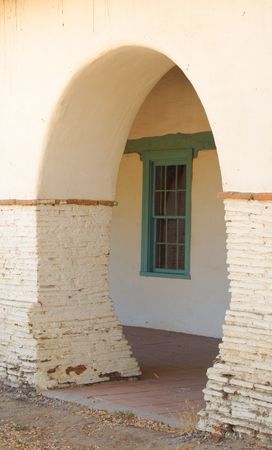Archway at the San Juan Bautista Mission with a green window in the backgroundの写真素材