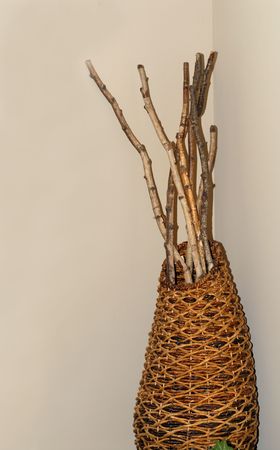 A woven basket with several sticks in itの写真素材