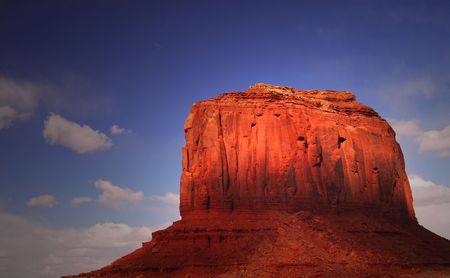 Large rock formation being struck by dramatic lighting in the Navajo nation land of Monument Valleyの写真素材