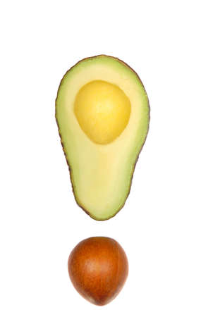 Fresh cut avocado and seed looking like an exclamation point.
