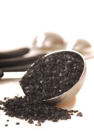 Black lava Hawaiian sea salt in a measuring spoonの写真素材