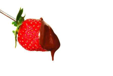 Fresh red strawberry with dark chocolate sauce dripping off of itの写真素材
