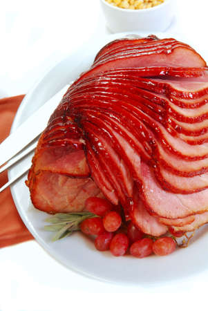 Holiday spiral cut ham with sage, grapes and cornの写真素材
