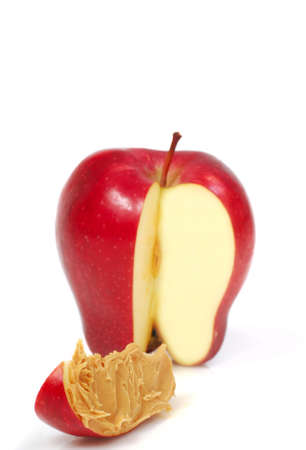 Delicious red apple slice with peanut butter spread on itの写真素材