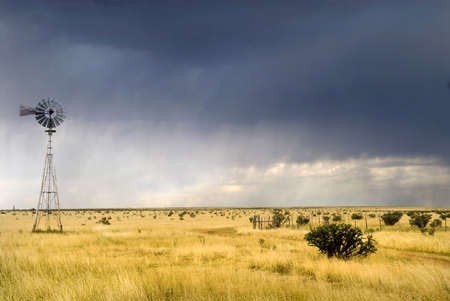 Windmill in a Texas field along Route 66 with a storm approachingの写真素材