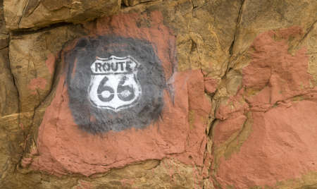 Old historic Route 66 sign that has been painted onto rocks in New Mexicoの写真素材