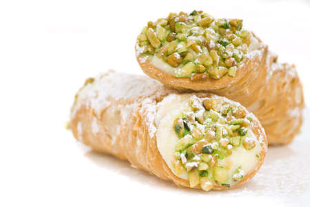 Delicious Italian Cannoli with pistachio nuts and powdered sugarの写真素材