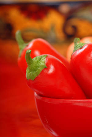 Variety of colorful chili peppers on display in a Red Bowlの写真素材