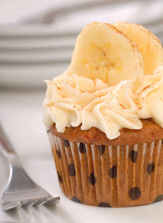 Delicious carrot cake cupcake with cream cheese frosting, bananas and cinnamon.の写真素材
