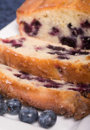 Freshly baked lemon blueberry bread sliced on a platter waiting to be servedの写真素材