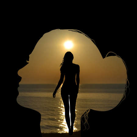Double exposure of a woman head combined with a woman silhouette over a seaside shore at sunriseの写真素材