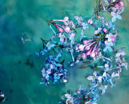 Lilac flowers floating over green water with ebru effect