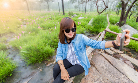 Beautiful woman is taking a picture with a mobile phoneの写真素材