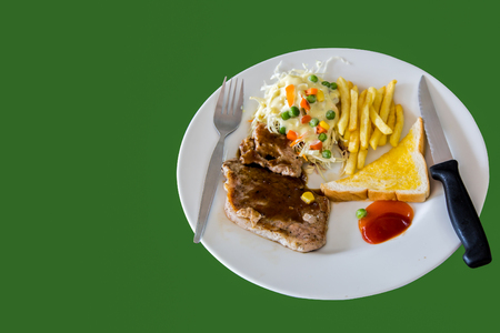 Steak, french fries, bread, salad on a white plate with knife and forkの写真素材