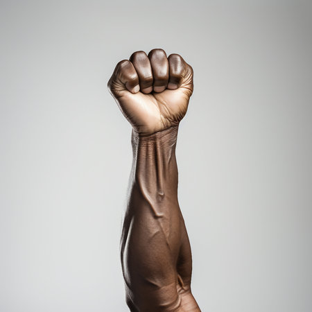 Close up of human hand with clenched fist isolated on grey background.の素材